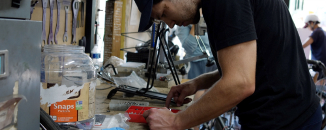 Josh works on a bike at the shop